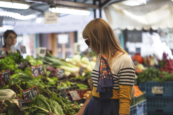 Vegan probiotics: A woman looks through a produce market