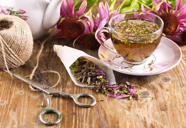 A satchel of antiviral herbs next to a cup of echidna tea