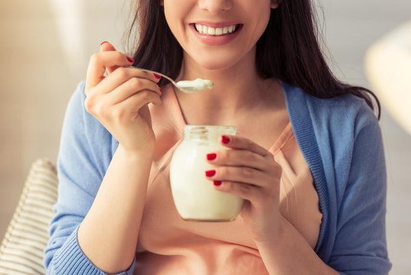 Kefir vs. yogurt: A woman eats yogurt